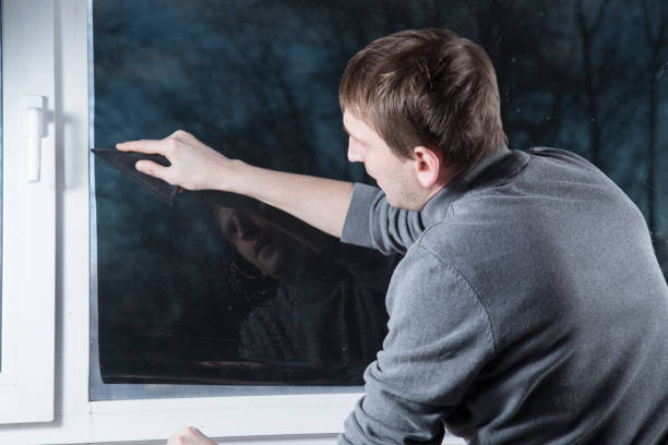 istock Installation of window film in the office. 1299149490