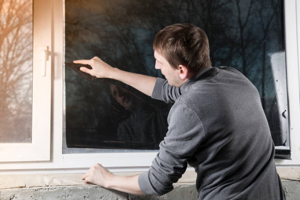 istock Installation of window film in the office. 1299149505