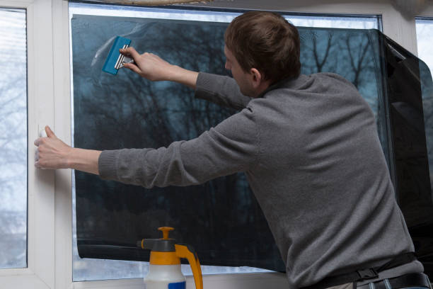 istock Installation of window film in the office. 1299149514