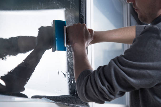 istock Installation of window film in the office. 1299149546
