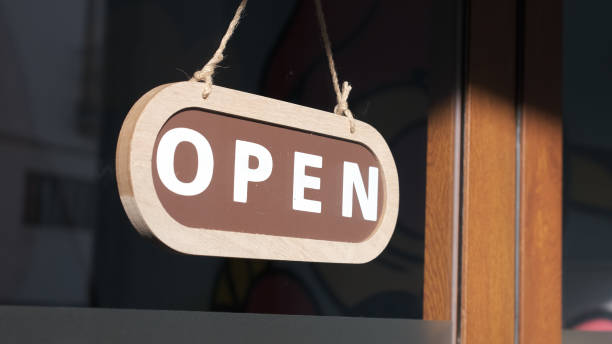 istock Small business opening up. Turning the sign to open 1299153552