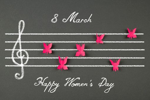 Musical score of the butterfly shape and text    ,, 8 March Happy Women's day