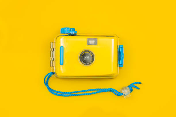 istock Stylish Yellow-blue camera for underwater photos on a yellow background. 1299154717