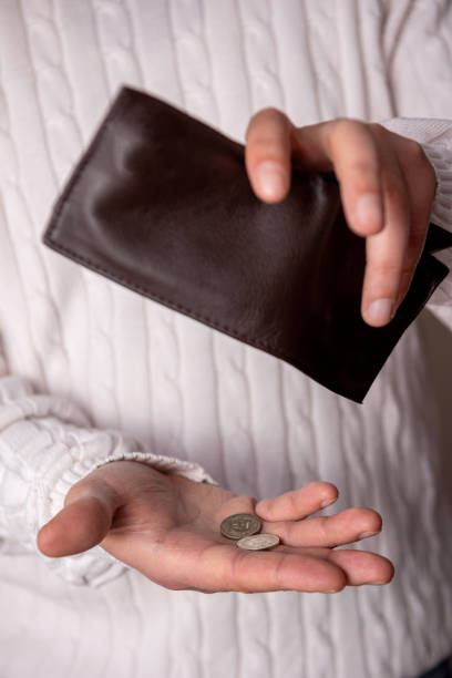 istock The last coins are spilled from the poor man's wallet. 1299155949