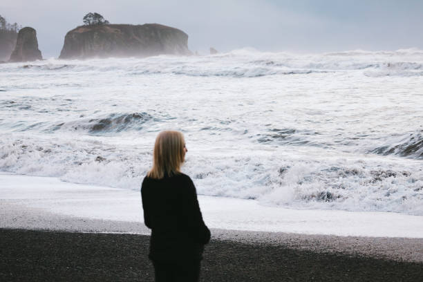 istock Young Woman Exploring Olympic Peninsula Coastline 1299155970