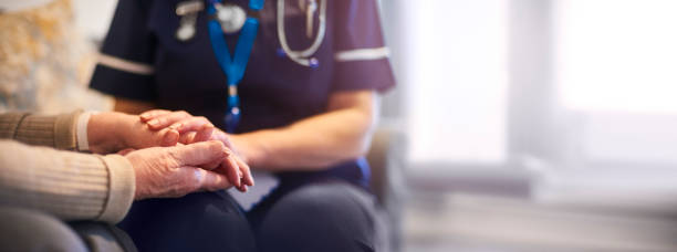 istock Nurse comforting patient at patient's home 1299156235