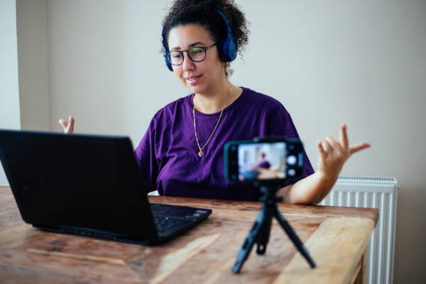 istock Female gamer vlogging to play game on laptop, 1299159792