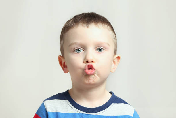istock Boy, kid performs articulation exercises for the tongue, correct pronunciation, vocals, dental concept, speech therapy 1299161918