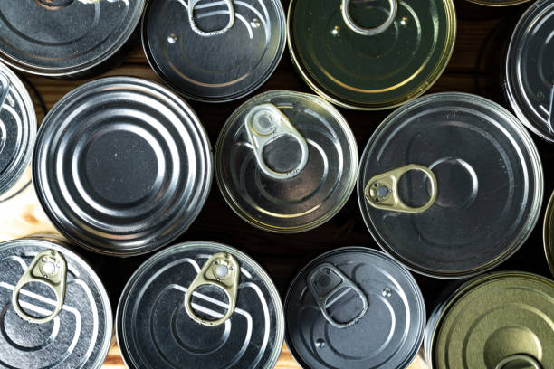 istock Tin cans with food on the table. 1299162840