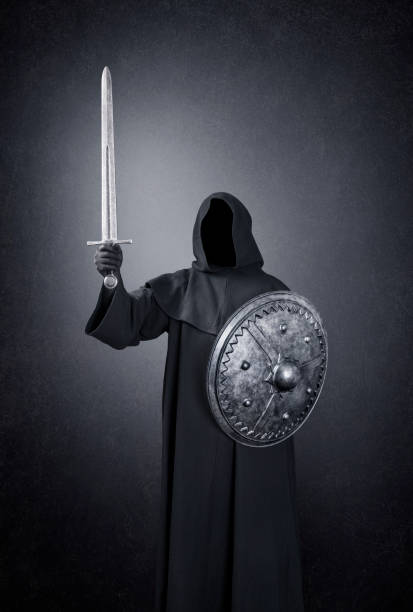 istock Ghostly figure with sword and round shield in the dark 1299163180