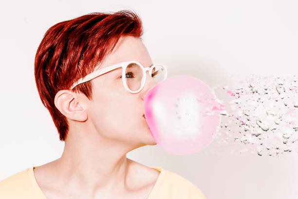 istock red-haired woman with glasses and big bubble of chewing gum with liquify effect 1299166345