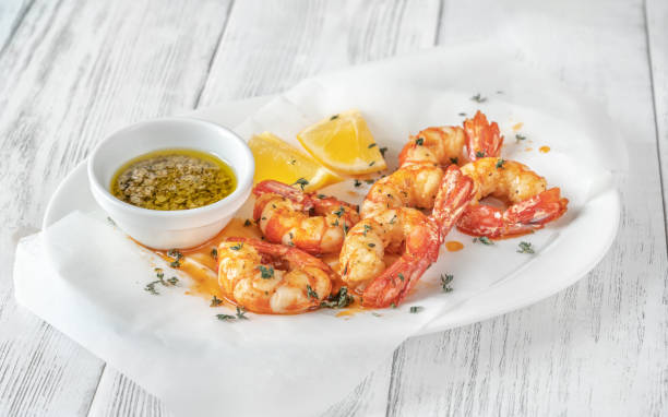 Shrimps with thyme and lemon wedges Cooked shrimps with thyme and lemon wedges on serving plate black tiger shrimp stock pictures, royalty-free photos & images
