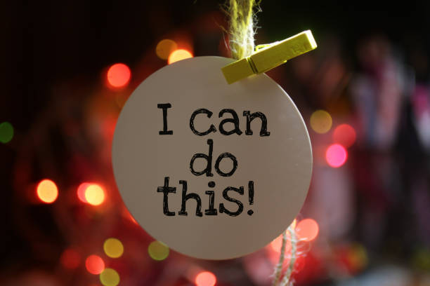 I can do this! Positive words with motivational notes concept on tag label paper hanging on rope.