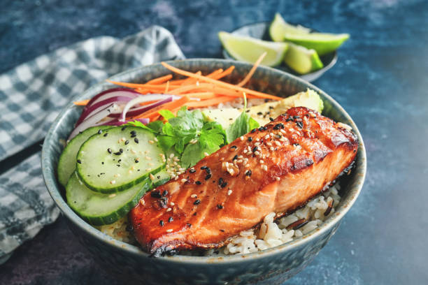 istock Spicy Salmon Bowl with Rice, Carrots, Cucumber and Avocado 1299168816