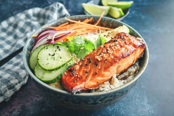 istock Spicy Salmon Bowl with Rice, Carrots, Cucumber and Avocado 1299168936
