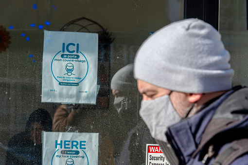Montreal, CA - 24 January 2021: Signage stating that non-medical masks or face coverings are required to enter the store