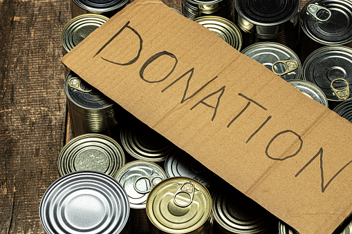 Food donations on the table. Text Donation. Close up.