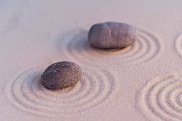 istock Zen garden stones on sand with ornament 1299172224