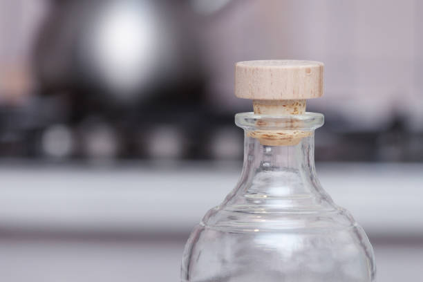 istock Transparent bottle with wooden cork in the kitchen. 1299172523