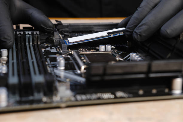 istock Engineer repairman holding hands in black gloves hard drive SSD to insert into the computer or laptop 1299173208