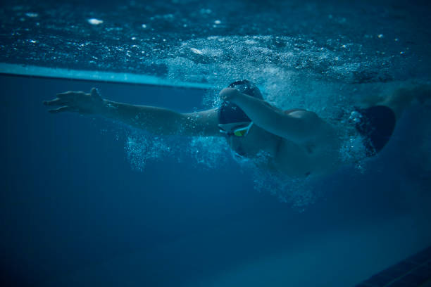 istock Amputee professional swimmer butterfly swimming in indoor pool 1299174516
