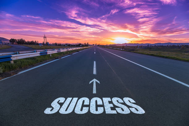 success in the asphalt road success in the asphalt road at the sunset success stock pictures, royalty-free photos & images