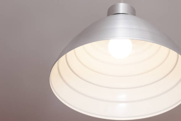 istock Metal grey lamp hanging on the cable. 1299174547