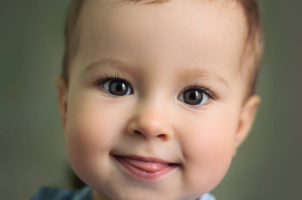 istock Baby smiling, close up. Children's emotions. Positive Emotion 1299177550