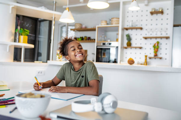 istock Cute African American girl studying at home 1299178245