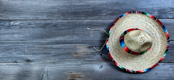 Traditional large sombrero hat for Cinco de Mayo holiday celebration on rustic wooden boards