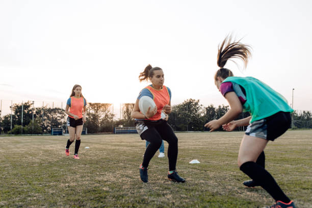 istock Girls practicing attack and defence on the rugby training 1299180751