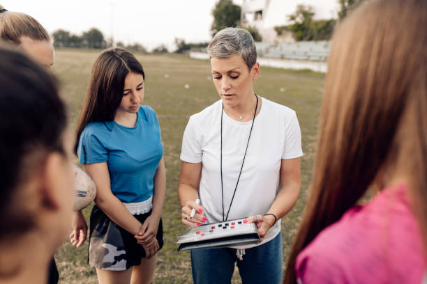 istock Female rugby coach making a play tactic before the game 1299180759
