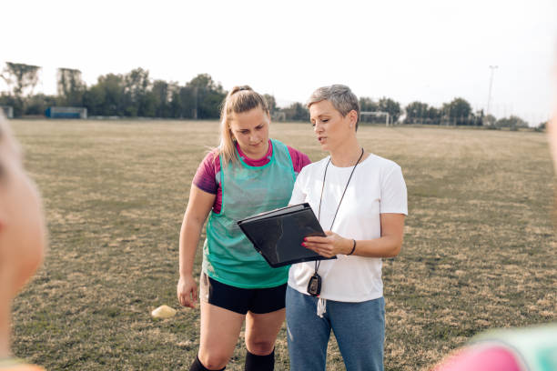 istock Female rugby coach and her payer planning the game tactics 1299180767