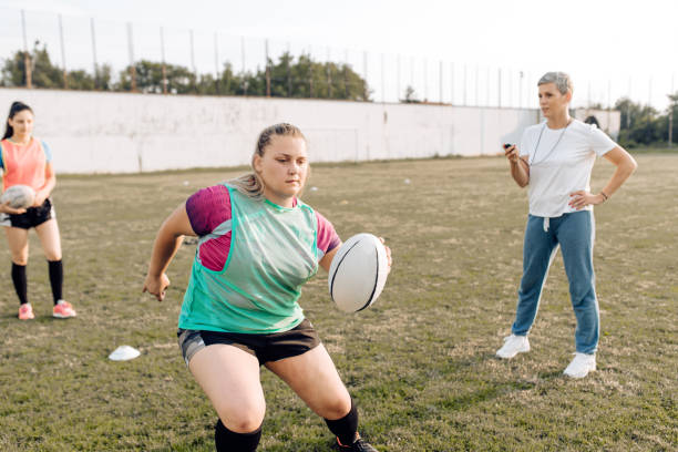 istock Woman coaching female rugby team 1299180773