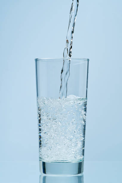 istock Pouring water. Pouring fresh clean drinking water to glass. 1299184302