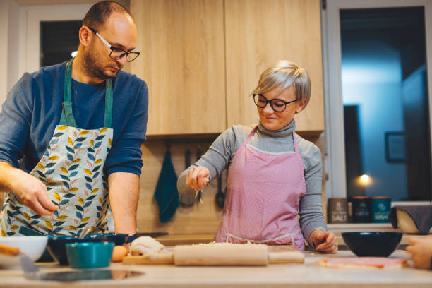 istock Couple cooking together, making pizza for dinner 1299189190