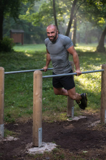 istock Young Sportsman Working Out In A Park 1299189315