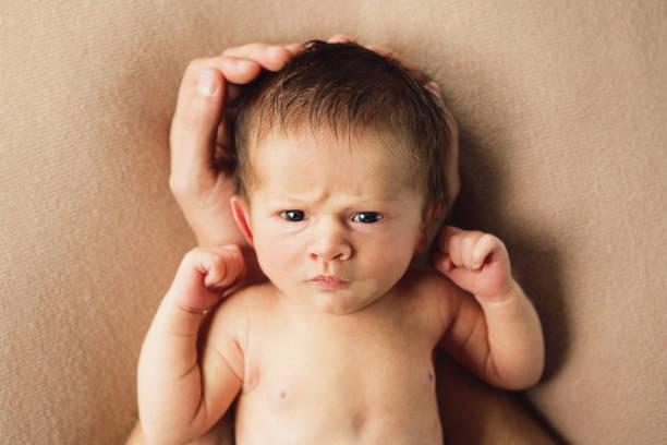 istock Newborn Baby in Father's Hands 1299191943