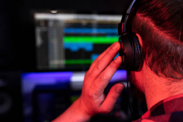 istock White young DJ is recording a new track in the stereo studio workplace using song mixer and microphone 1299192938