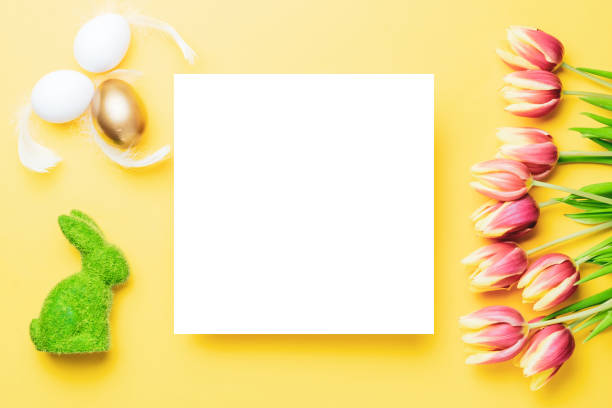 istock Easter background. Golden, white colour egg in basket with spring tulips, feathers on pastel yellow background in Happy Easter decoration. Spring holiday top view concept. 1299194156
