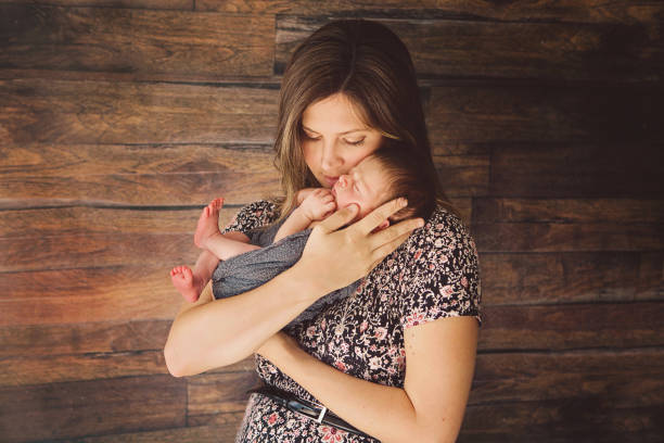 istock Mother Holding Newborn 1299194250