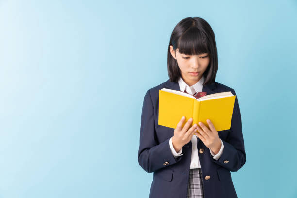 istock girl who reads a book,School uniform, 1299194325
