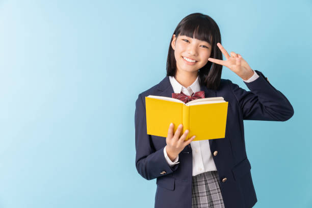 istock girl who reads a book,School uniform, 1299194881