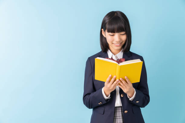 istock girl who reads a book,School uniform, 1299194912