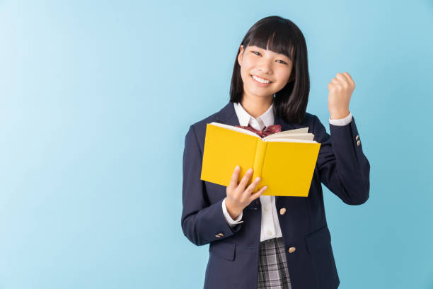istock girl who reads a book,School uniform, 1299194921