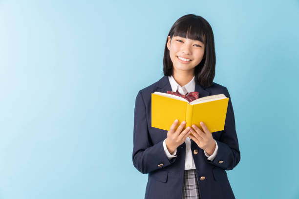 istock girl who reads a book,School uniform, 1299194939