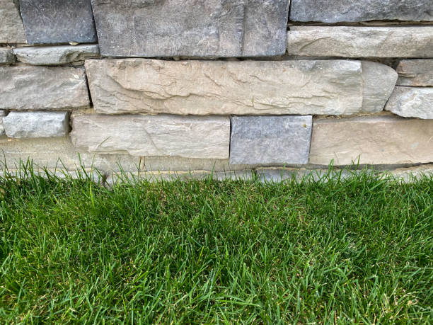 istock close-up view of stone wall barn shed building with fresh cut grass edge 1299196810