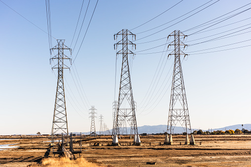 High voltage PG&E electricity towers and power lines on the shores of San Francisco Bay, Menlo Park, California