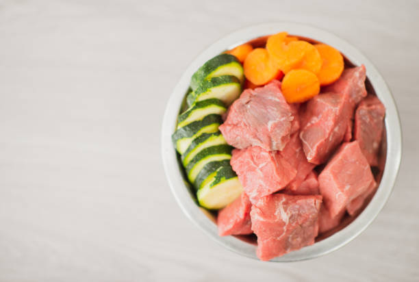 cook raw meat in a frying pan with vegetables at home. Quick snack and both