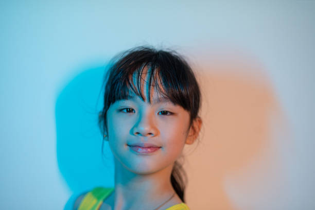 headshot asian chinese young girl looking at camera split tone